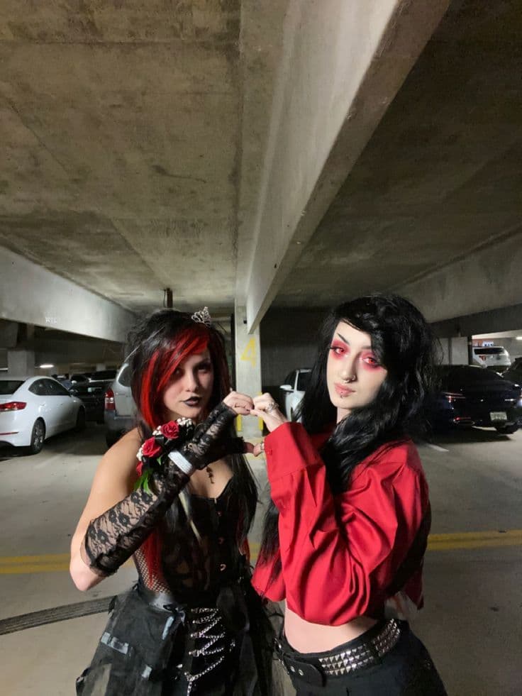 Alternative couple with matching emo styles enjoying a concert together after connecting through an emo dating app